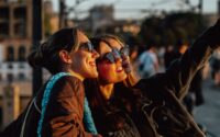 Two smiling women taking a selfie outdoors